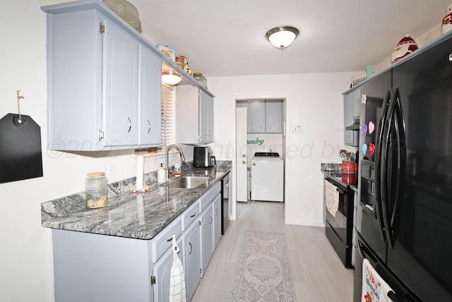 2904 Pittsburg St, Amarillo, TX 79103 - kitchen with black appliances, washer / clothes dryer, dark stone counters, and extractor fan