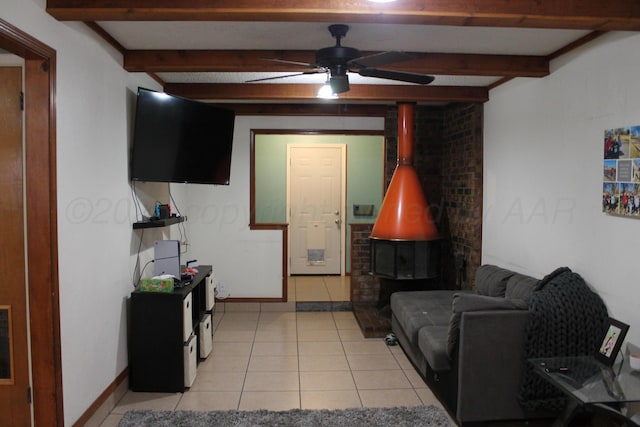 2924 Carter St, Amarillo, TX 79103 - living room featuring beam ceiling, a ceiling fan, light tile patterned flooring, and a wood stove