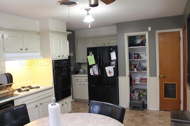 2924 Carter St, Amarillo, TX 79103 - kitchen with black appliances, a warming drawer, under cabinet range hood, light countertops, and a ceiling fan