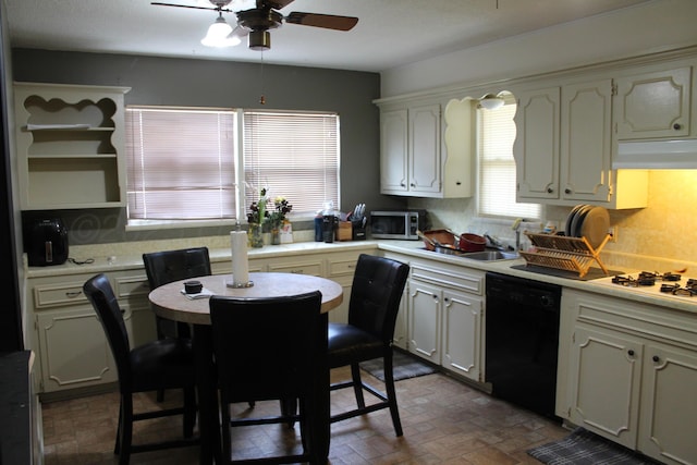 2924 Carter St, Amarillo, TX 79103 - kitchen with black dishwasher, stainless steel microwave, ceiling fan, white gas stovetop, and brick patterned flooring