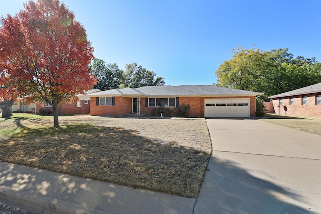 ranch-style home featuring a garage and a front yard