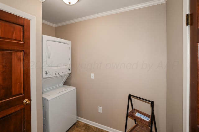 washroom with stacked washer / dryer and ornamental molding