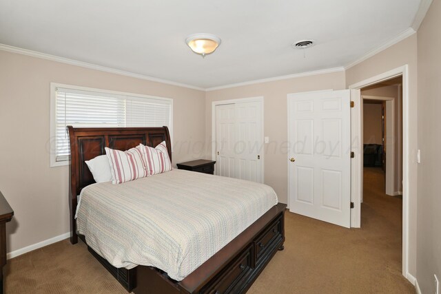 bedroom featuring carpet, ornamental molding, and a closet