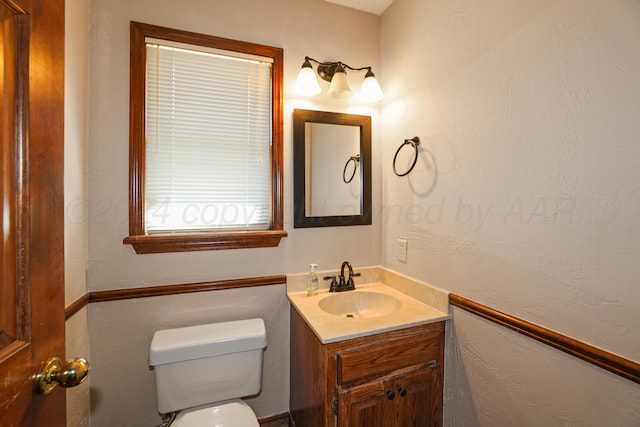 bathroom featuring vanity and toilet