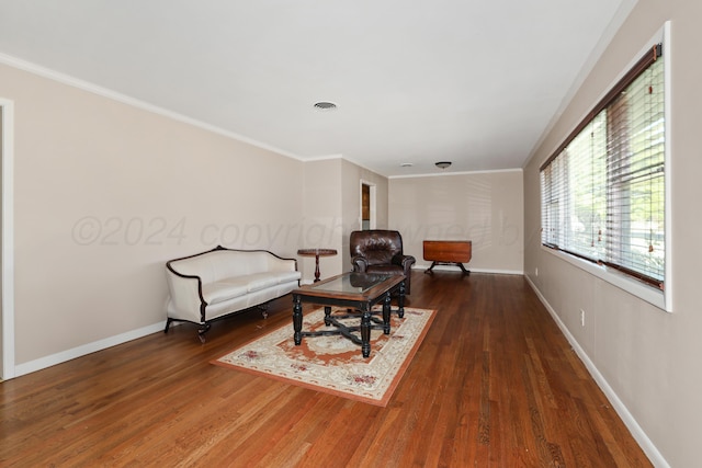 living room featuring dark hardwood / wood-style flooring and ornamental molding