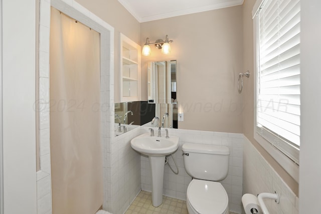 bathroom with sink, ornamental molding, tile walls, and toilet