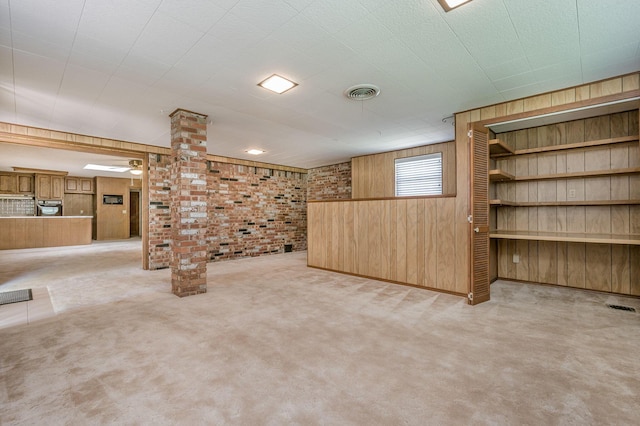 below grade area with wooden walls, carpet flooring, and brick wall