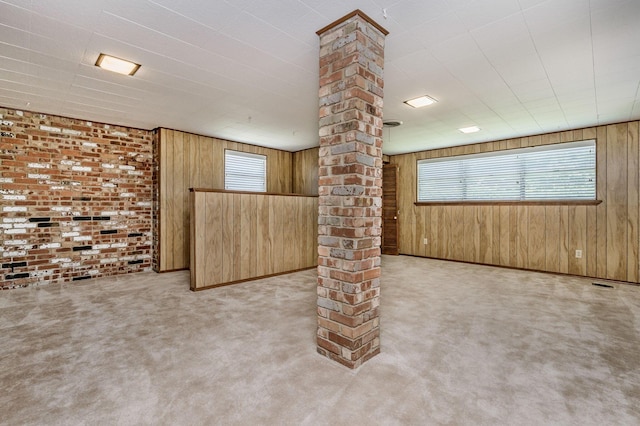 basement featuring wood walls, carpet flooring, and baseboards