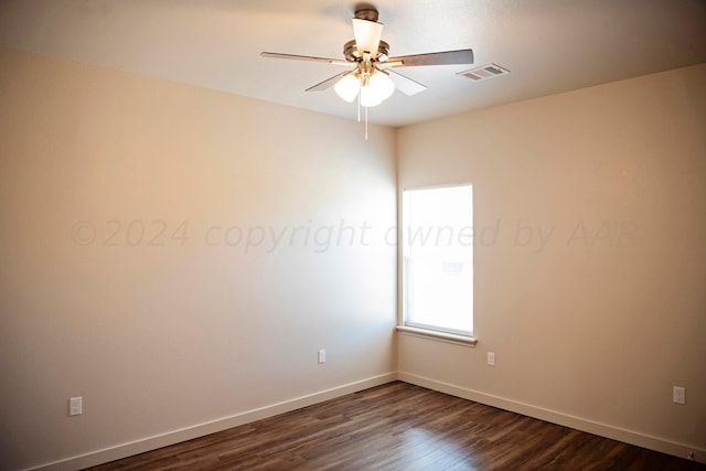 spare room featuring ceiling fan and dark hardwood / wood-style floors