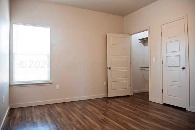 unfurnished bedroom featuring dark wood-type flooring