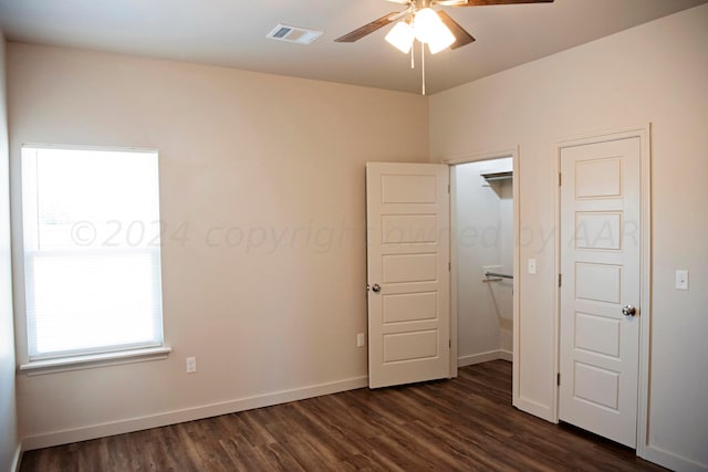 unfurnished bedroom featuring dark hardwood / wood-style floors and ceiling fan