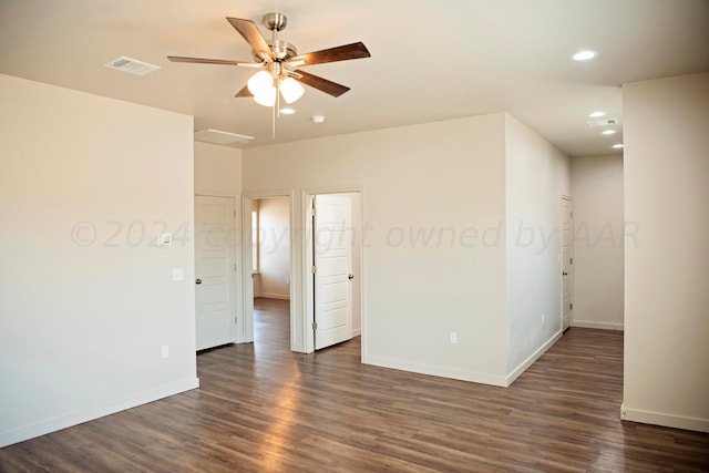 spare room with dark wood-type flooring and ceiling fan