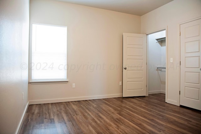 unfurnished bedroom with dark wood-type flooring