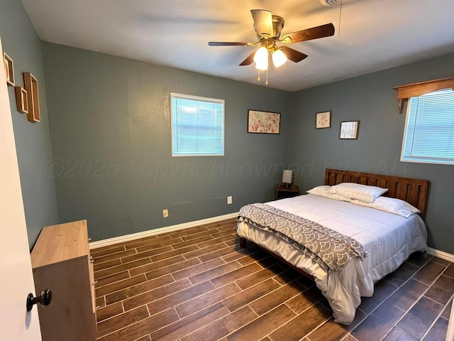 bedroom featuring ceiling fan, wood finish floors, and baseboards