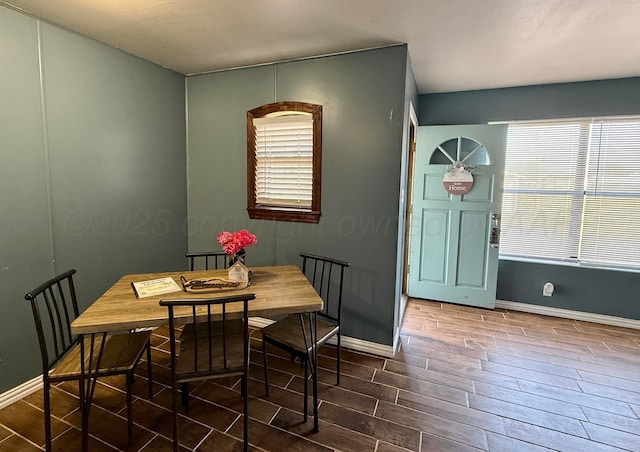 dining room with wood finished floors and baseboards