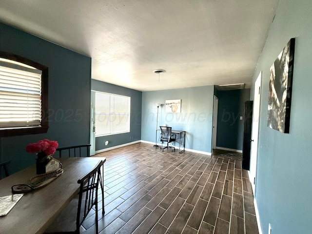 dining room featuring baseboards, visible vents, and wood tiled floor