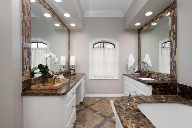 bathroom featuring crown molding, plenty of natural light, and vanity