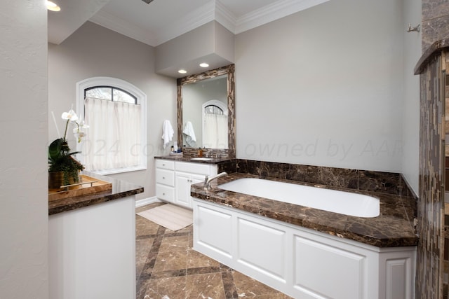 bathroom featuring vanity, crown molding, and a tub to relax in