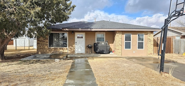 bungalow-style home with a patio