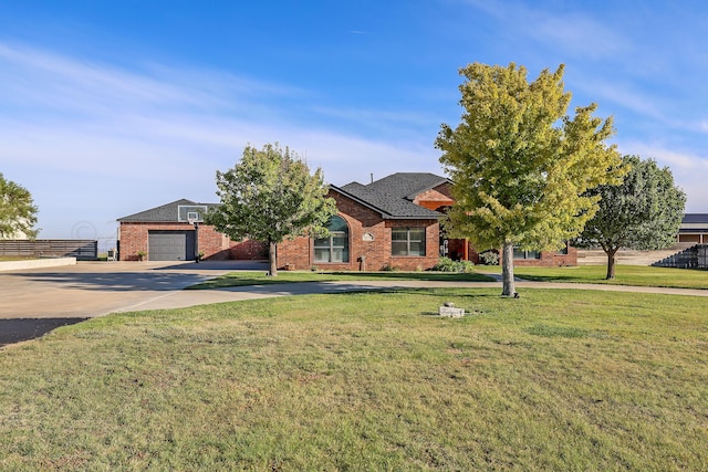 view of front of house with a garage and a front yard