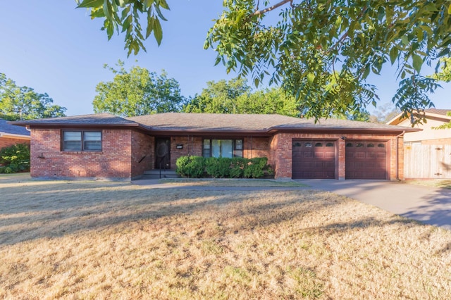 ranch-style house featuring a front yard and a garage