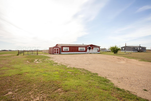 rear view of house featuring a storage shed and an outbuilding