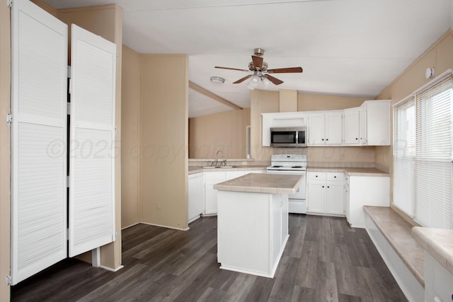 kitchen with white appliances, lofted ceiling, a center island, ceiling fan, and dark wood finished floors