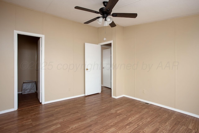unfurnished bedroom with wood finished floors, baseboards, and ceiling fan