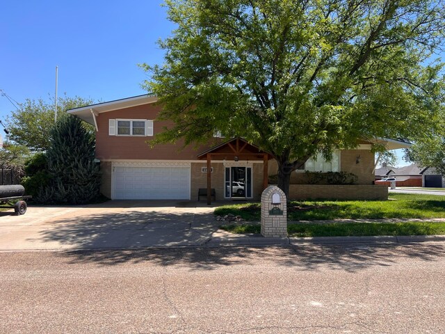 1400 16th St, Hereford, TX 79045 - obstructed view of property with driveway and an attached garage