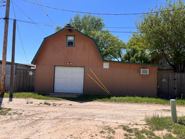 1400 16th St, Hereford, TX 79045 - garage with dirt driveway, a garage, and fence