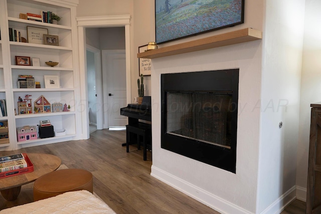 living room with wood finished floors and baseboards