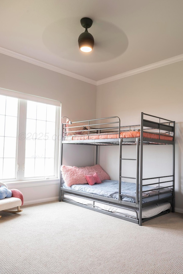 bedroom featuring carpet, crown molding, baseboards, and a ceiling fan