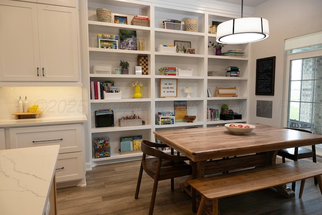 dining space with wood finished floors