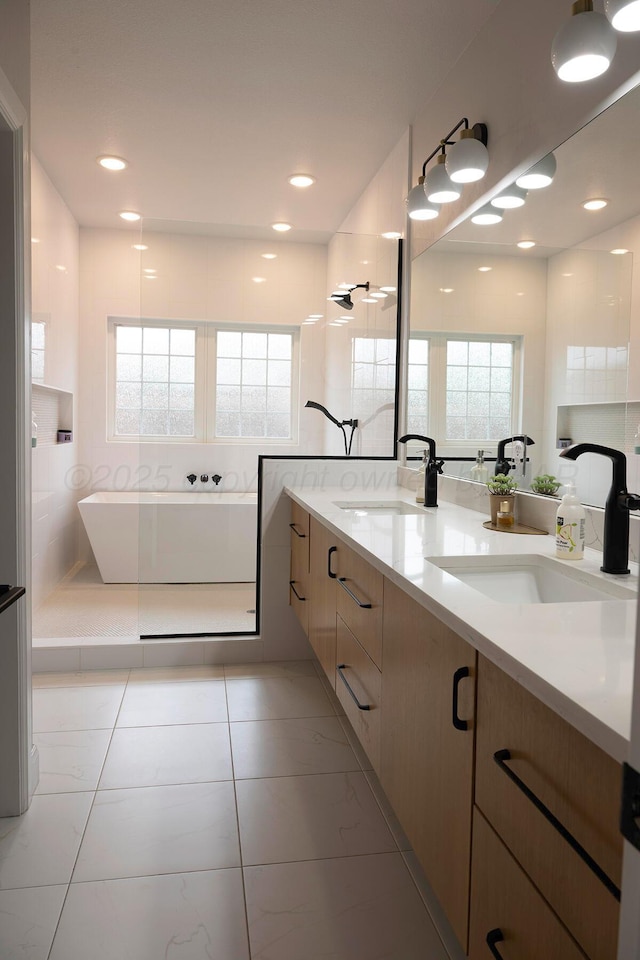 bathroom featuring a freestanding tub and double vanity