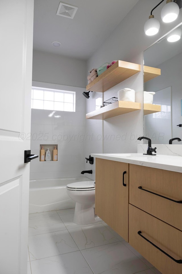 full bath featuring toilet, vanity, and marble finish floors