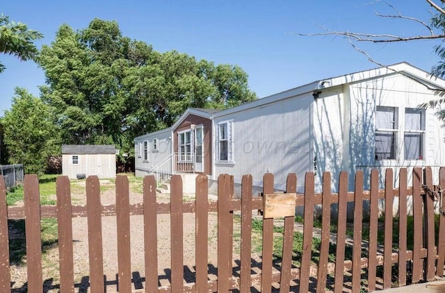 view of side of property featuring a shed