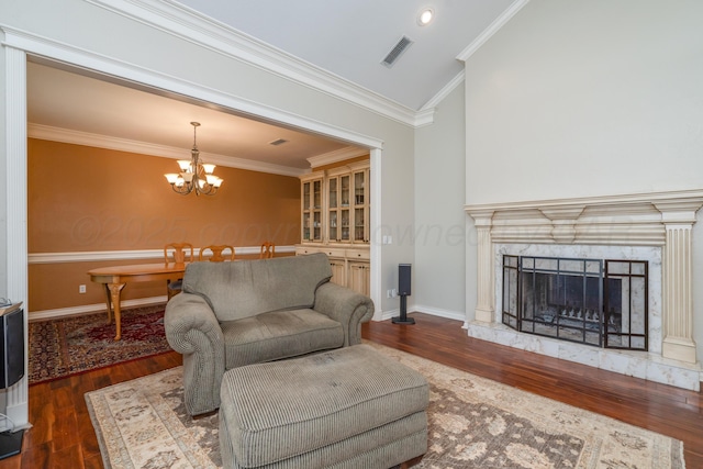 3501 Van Winkle Dr, Amarillo, TX 79121 - living area with wood finished floors, ornamental molding, a chandelier, vaulted ceiling, and baseboards
