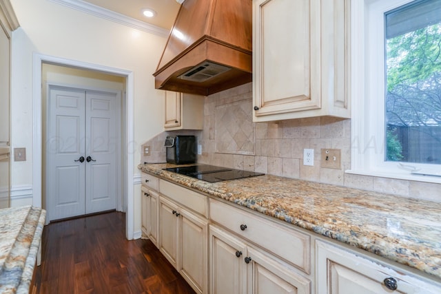 3501 Van Winkle Dr, Amarillo, TX 79121 - kitchen with premium range hood, cream cabinetry, black electric cooktop, dark wood-style floors, and crown molding