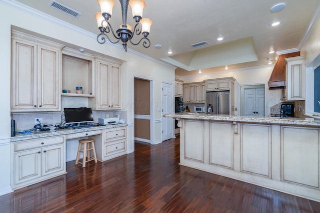 3501 Van Winkle Dr, Amarillo, TX 79121 - kitchen featuring appliances with stainless steel finishes, tasteful backsplash, dark wood-type flooring, a peninsula, and a tray ceiling