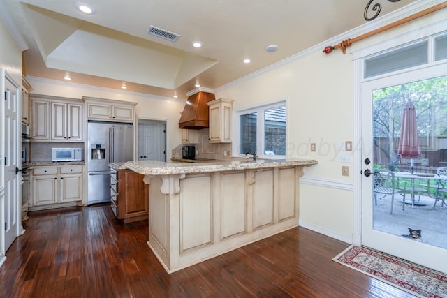 3501 Van Winkle Dr, Amarillo, TX 79121 - kitchen featuring high end fridge, white microwave, a peninsula, light stone counters, and tasteful backsplash