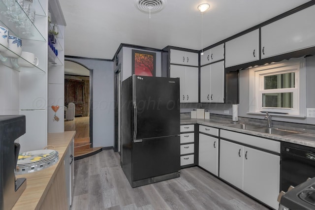1805 Broadmoor St, Amarillo, TX 79106 - kitchen featuring black appliances, light wood-type flooring, white cabinetry, and light countertops