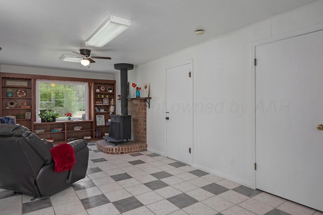1805 Broadmoor St, Amarillo, TX 79106 - living room featuring a wood stove and a ceiling fan