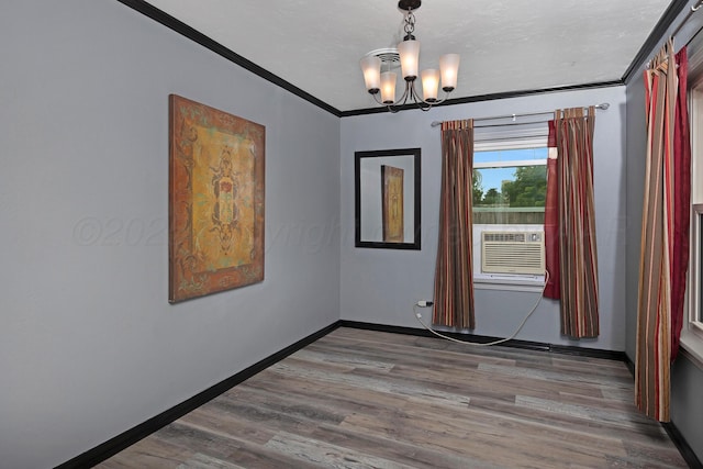 1805 Broadmoor St, Amarillo, TX 79106 - spare room with a chandelier, crown molding, wood finished floors, and cooling unit