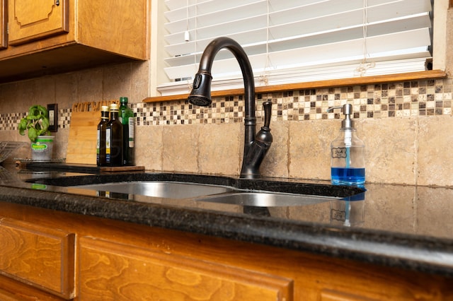 room details with a sink, brown cabinets, and tasteful backsplash