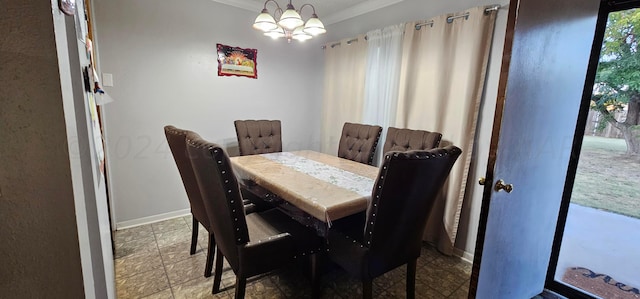 dining area featuring a chandelier and crown molding