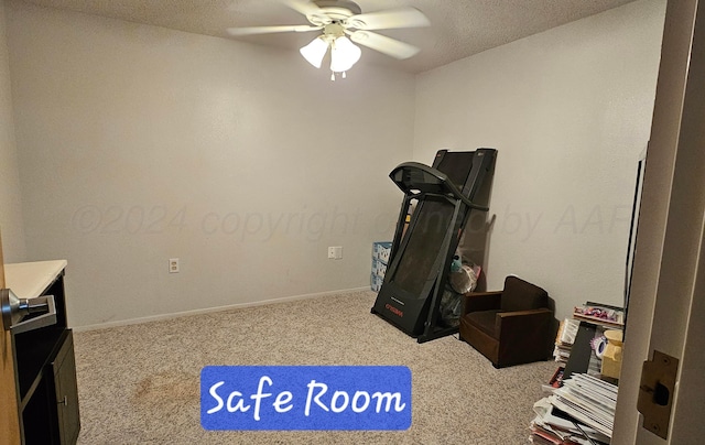 exercise room featuring ceiling fan, a textured ceiling, and carpet floors