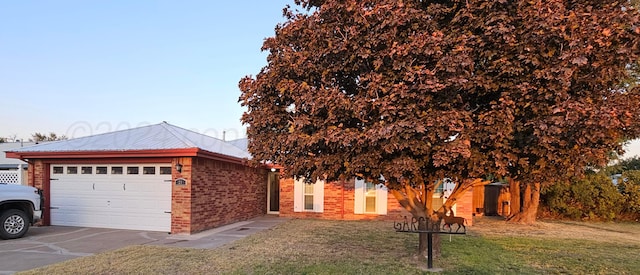 obstructed view of property with a garage and a front yard