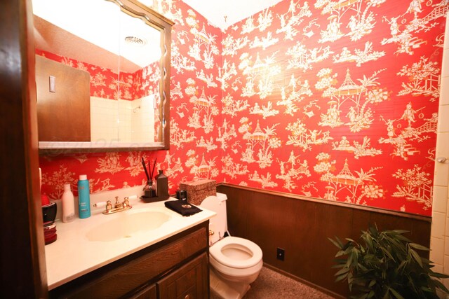 4204 Harmony St, Amarillo, TX 79109 - half bath with wallpapered walls, vanity, and a wainscoted wall