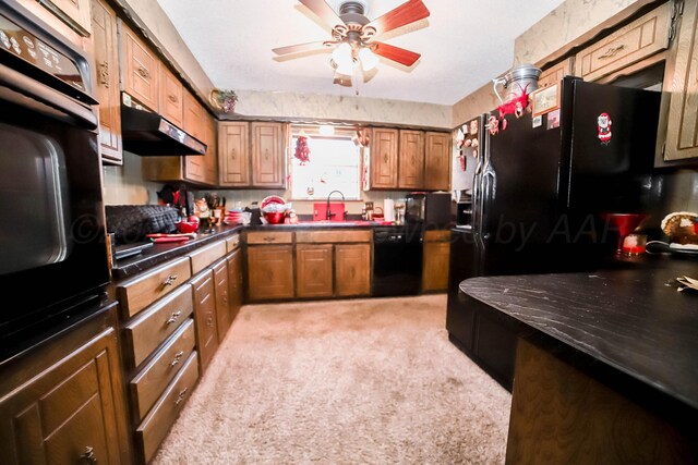 4204 Harmony St, Amarillo, TX 79109 - kitchen featuring black appliances, under cabinet range hood, dark countertops, and a ceiling fan
