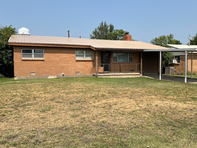 view of front of property with a carport and a front lawn